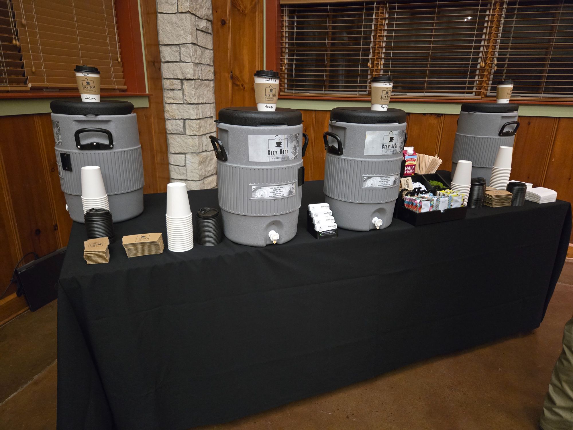 Brew Haha coffee catering setup with cambros, cups, half & half, and sugars